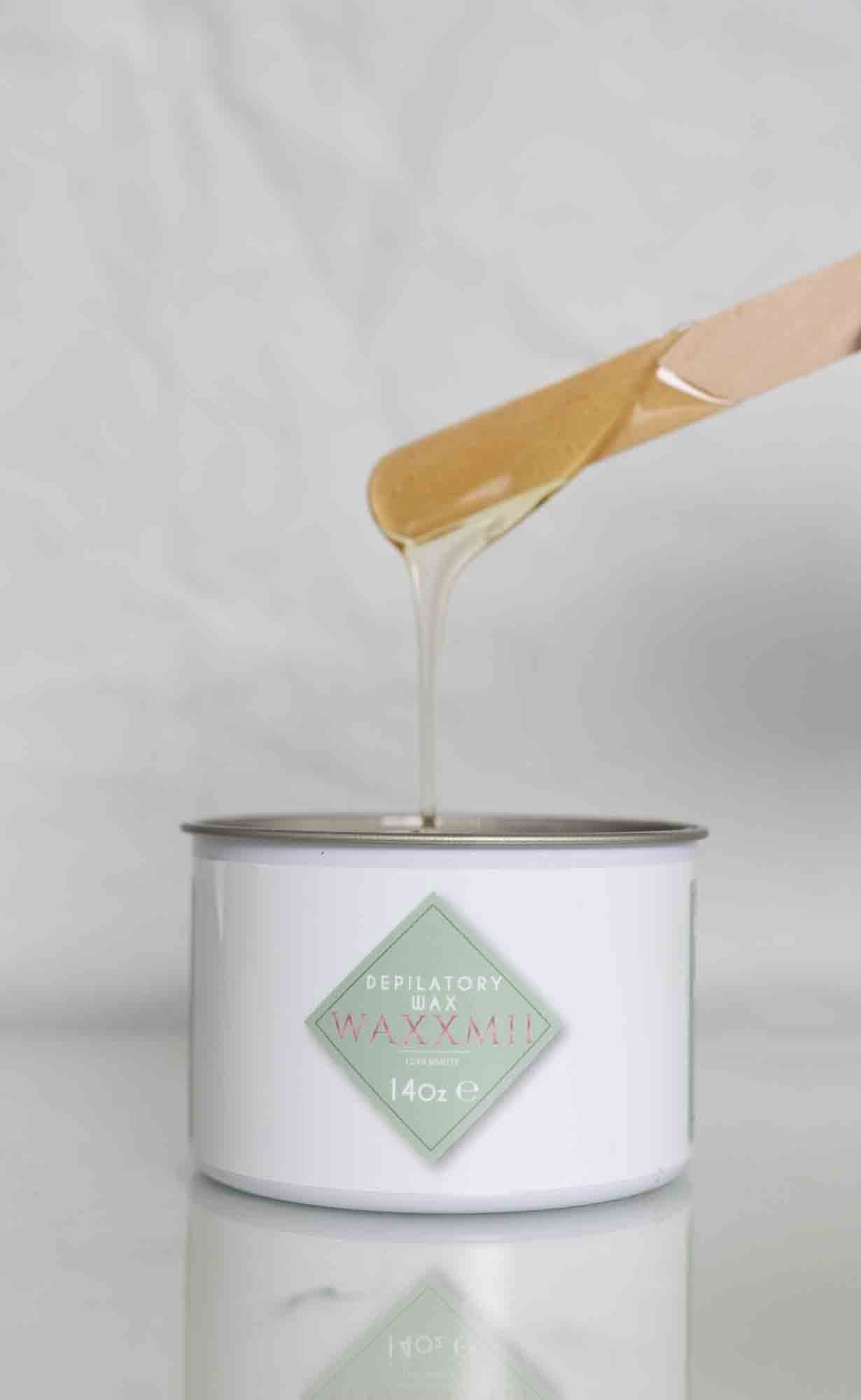 Waxxmii Honey Soft Wax consistency shown dripping from applicator stick