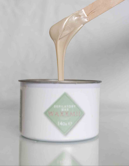 Waxxmii Zinc Oxide Soft Wax smooth consistency shown dripping from applicator stick
